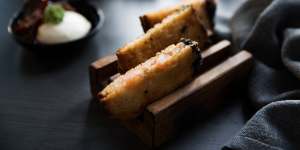 Prawn toasts are cutely served in wooden toast racks.