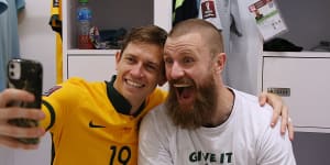 Craig Goodwin and Andrew Redmayne celebrate a famous Socceroos victory.