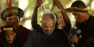Brazil’s now president-elect Luis Inacio Lula da Silva receives a headdress from Assurini indigenous people in Belem,Para,Brazil,in September. He has promised to reverse Bolsonaro’s forest policies.