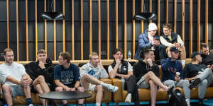 North Melbourne players listen to new coach Alastair Clarkson at his first press conference at the club.