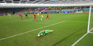 Denmark goalkeeper Kasper Schmeichel dives to no avail as Leckie’s shot heads for the net.