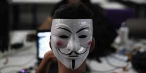 A hacker with a Guy Fawkes mask,a symbol linked to the Anonymous hacking movement. Some hackers affiliated with the collective have declared their own “cyber war” on Russia.