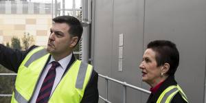 CEO of Transgrid,Paul Italiano,shows lord mayor Clover Moore the new Tesla Battery installed at the Alexandra Canal Depot.