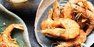 Spicy finger food for a party:Crispy school prawns with harissa mayonnaise.