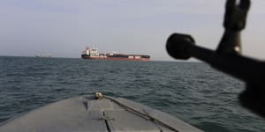 A speedboat of Iran's Revolutionary Guard trains a weapon toward the British-flagged oil tanker Stena Impero,which was seized in the Strait of Hormuz on July 19.