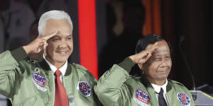 Ganjar Pranow (left) and his running mate Mahfud MD arrive at a televised debate this month.