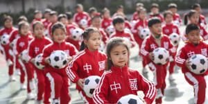Children perform football rhythmic exercises in Huaian,Jiangsu Province,China,on Thursday.