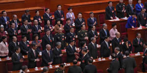 Xi Jinping (centre) and Premier Li Qiang (to his right) leave the hall at the end of Monday’s National People’s Congress.