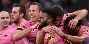 Sunia Turuva celebrates one of his three tries against the Roosters on Thursday night.