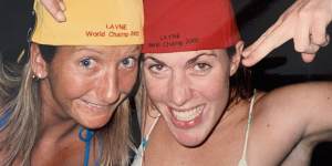 Farris (at right) with world champion Layne Beachley in 2001 (amused by their caps,which were mistakenly printed with the year 2002).