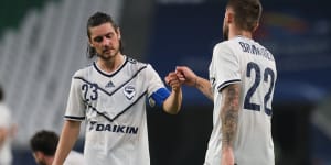 Jake Brimmer and Marco Rojas console each other after Melbourne Victory’s loss in Qatar. 