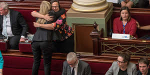 After a marathon 29-hour sitting to pass euthanasia laws in 2017,Fiona Patten stands on the seats to hug Labor’s Harriet Shing.