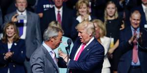 Donald Trump welcomes Nigel Farage to the stage.