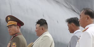 North Korea leader Kim Jong-un,second left,looks at what is says a new nuclear attack submarine “Hero Kim Kun Ok” at an unspecified location on Wednesday.