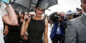 Hilary Swank dodging a shower at Derby Day.
