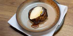 Tarte tatin topped with vanilla ice-cream.