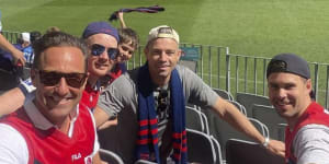 Hayden Burbank (front left) and Mark Babbage (back left) at the AFL grand final. 