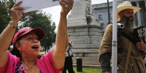 Maria Calef,of Columbia,South Carolina,waves a sign as she celebrates in front of the South Carolina statehouse.