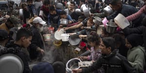 Palestinians line up for a free meal in Rafah,Gaza Strip,on Thursday.