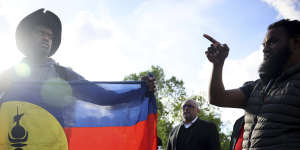 Demonstrators hold Kanak and Socialist National Liberation Front (FLNKS) flags during a gathering in Paris.