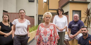 Frankston South apartment owner Kerry Ould (centre) in 2019 with her neighbours. Government-funded works to replace potentially dangerous cladding were finally been completed at her home last week.