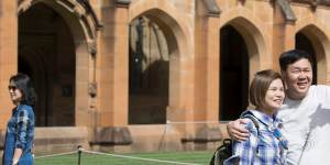 A group of Chinese people take a tour of the main quadrangle at Sydney University. Australia will become more Asian over time,says Malaysia's Prime Minister.