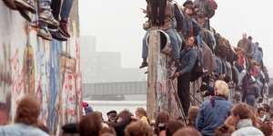 Berliners celebrate on top of the wall on Sunday,November 12,1989.