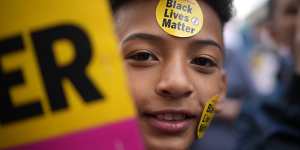 A young boy wears Black Lives Matter stickers at the protest.