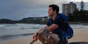 Gareth Andrews on Manly Beach takes a break during training ahead of The Last Great First,a 110-day trek across Antarctica.