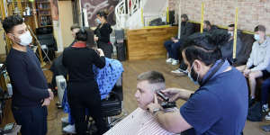 Customers have their hair cut at the Unique Traditional barber’s in Whitley Bay,England on Monday.