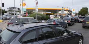 Drivers queue for fuel at a petrol station in London on Tuesday. Long lines of vehicles have formed at many gas stations around Britain since Friday,causing spillover traffic jams on busy roads.