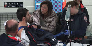 Christian Petracca is comforted by his mother Elvira after he was injured in the game against Collingwood.