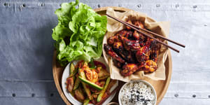 Sticky Korean chicken wings with kimchi-pickled cucumbers.