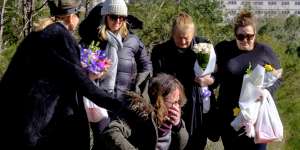 Courtney Herron's mother weeps at the site of her death in Royal Park as her grandmother and other family members stand by. 