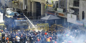 Police use water canon and tear gas to disperse the protesters. 