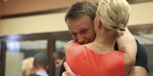 Russian opposition leader Alexei Navalny embraces his wife,Yulia,in a courtroom as he was released from custody in Kirov,Russia,2013. 
