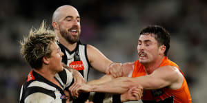 Magpie Jack Ginnivan and Lachie Ash of the Giants clash.