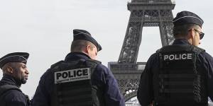 FILE - Police officers patrol the Trocadero plaza near the Eiffel Tower in Paris,Tuesday,Oct. 17,2023. The French Interior Minister said Friday that security authorities have foiled a plan to attack soccer events during the Paris Olympics. Gerald Darmanin said in a statement Friday May 31,2024 that an 18-year-old man from Chechnya was arrested on May 22 on suspicion of being behind a plan to attack soccer events that will be held in the city of Saint-Etienne,southwest of Lyon. (AP Photo/Michel Euler,File)