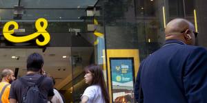 Customers line up outside an Optus shop front on George Street in Sydney during a country-wide network outage.