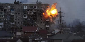 An explosion is seen in an apartment building after Russian’s army tank fires in Mariupol,Ukraine,on Friday.
