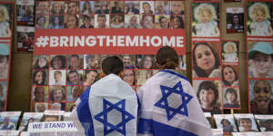 Children look at photographs of Israelis kidnapped by Hamas.