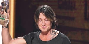 Emotional Keith Urban wins top prize at US country music awards