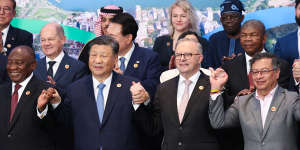 ​Prime Minister Anthony Albanese and Chinese President Xi Jinping hold hands for the G20 group photo in Rio de Janeiro in November.