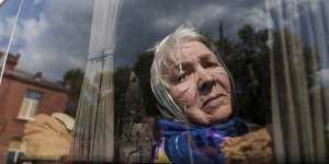 Liudmila,85,whose husband was killed at home by a Russian airstrike looks through the window of a bus after being evacuated from Vovchansk,Ukraine,on Sunday.