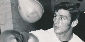 Australian boxing great Johnny Famechon pounds the speed ball in the gym.