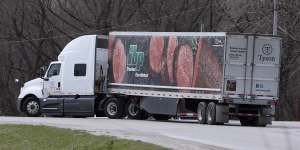 A truck turns onto a highway after leaving the Tyson Foods pork plant in Perry,Iowa.