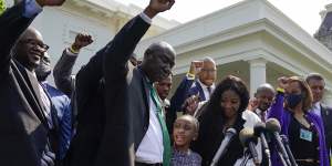 Lawyer Benjamin Crump,front centre,along with Gianna Floyd,daughter of George Floyd,and her mother Roxie Washington,and others talk with reporters after meeting with President Joe Biden at the White House.
