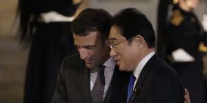 Closer:French President Emmanuel Macron,left,welcomes Japanese Prime Minister Fumio Kishida to Paris.