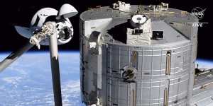 Elon Musk’s SpaceX Crew Dragon spacecraft,left,docking with the International Space Station.