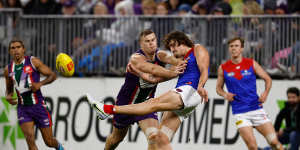 Luke Jackson gets a kick away under pressure from Sean Darcy who might be his teammate in 2023.